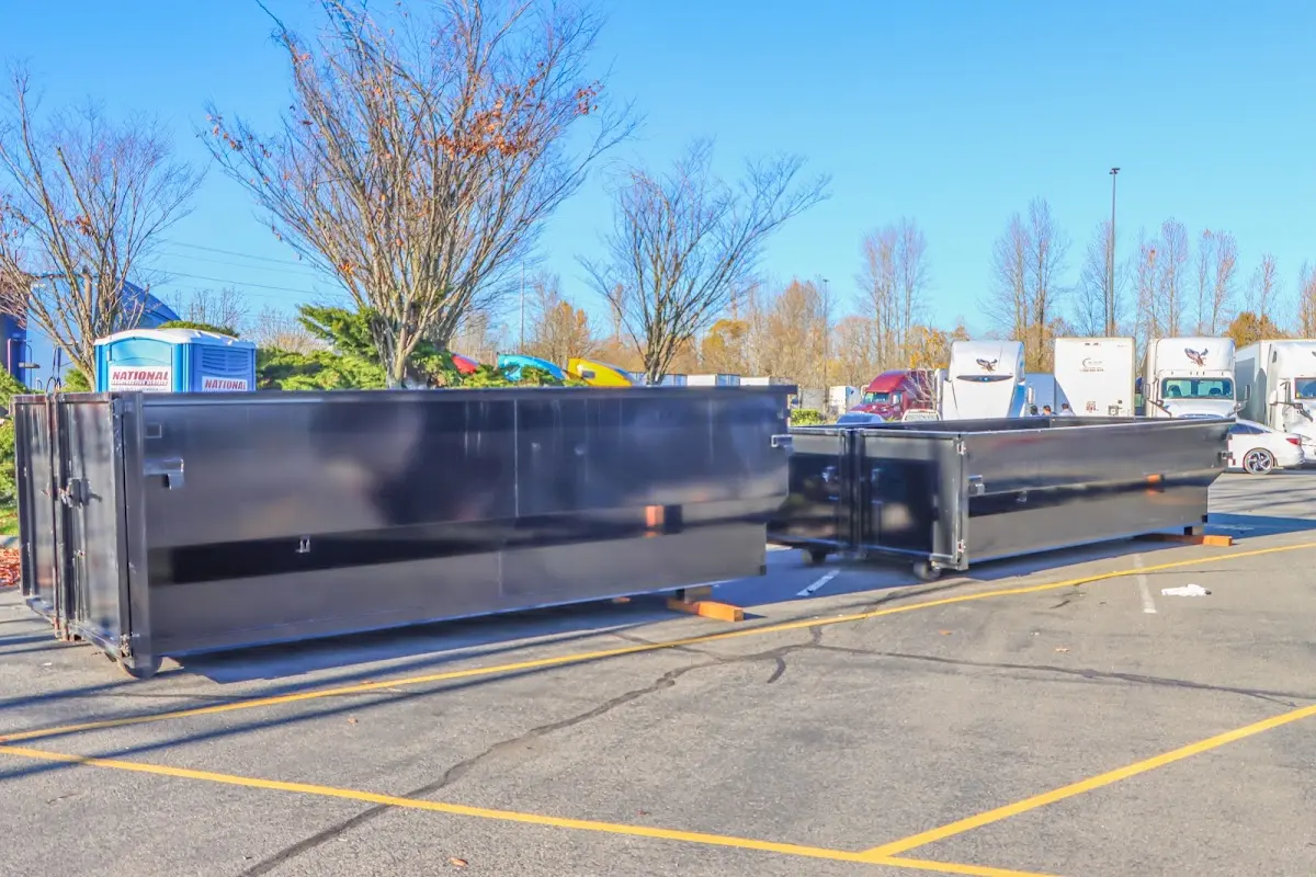 Professional dumpster rental service with roll-off container on residential driveway in Valley Park